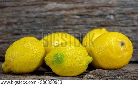 Yellow Lemons On Aged Wooden Background