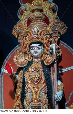 Goddess Saraswati Idol , Durga Puja Festival At Night. Shot Under Colored Light At Howrah, West Beng