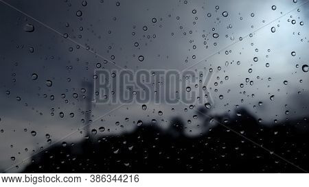 Rain Drop On The Glass Wall Tranparency And See The City Behind In Blur
