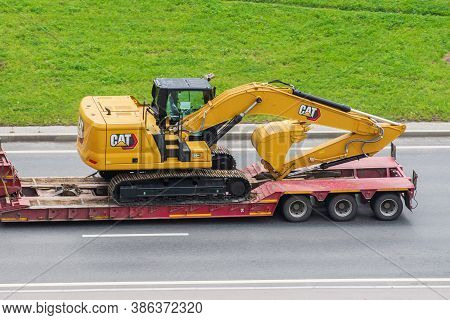 New Excavator Cat 320 Gc Truck Trailer Loaded Onto Cargo Platformon City Highway. Russia, Saint-pete