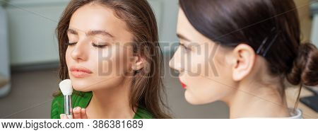Make Up Artist Applying Professional Make Up Of Tonal Foundation On The Face Of Beautiful Young Cauc