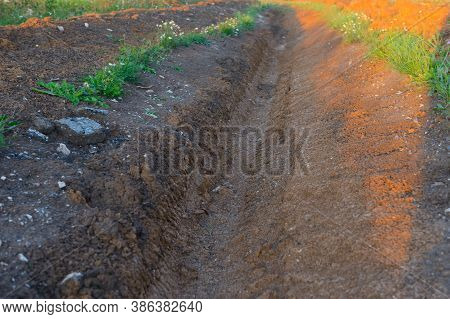 A Ditch Dug, A Trench In A Field On A Summer Day