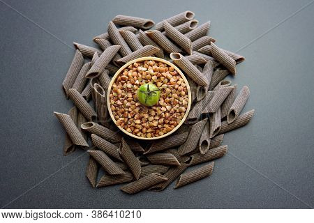 Penne Rigate Pasta Made From Buckwheat Flour. Penne Rigate Pasta On A Gray Background.