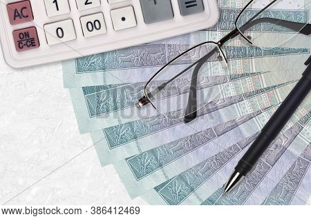 5 Egyptian Pounds Bills Fan And Calculator With Glasses And Pen. Business Loan Or Tax Payment Season