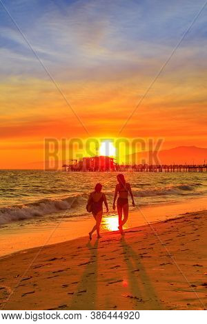 Santa Monica, California, Usa - August 8, 2018: Women Walking At Sunset On Seashore Of Santa Monica 