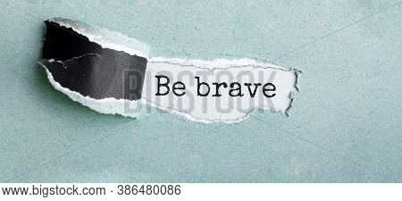 The Text Be Brave Appearing Behind Torn Brown Paper
