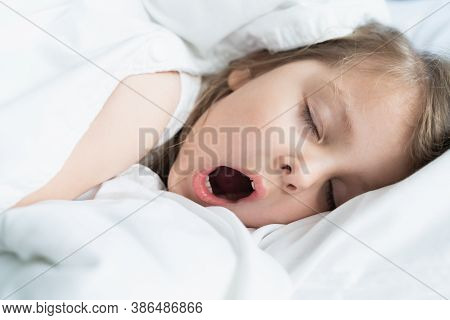 Little Snoring Girl, Sleeping On Pillow In Bed With Closed Eyes. Evening Late Going To Bed. Early Mo