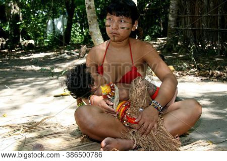 Porto Seguro, Bahia / Brazil - February 21, 2008: India Pataxo Breastfeeds Her Son In The Village Ja