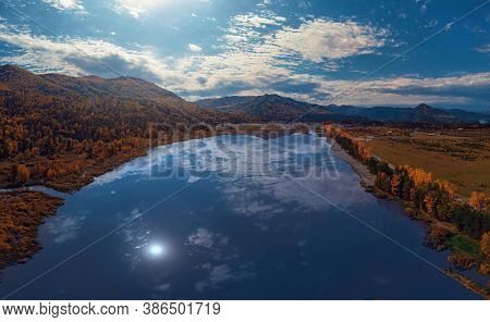 Aerial drone view of the Manjerokskoe lake, autumn shot, Altai Republic, Russia