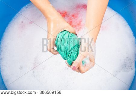 Closeup Young Asian Woman Use Hands Washing Color Clothes In Basin. Female Squeeze Wring Out Wet Fab