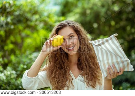 Cute Wowan In White Shirt Holding A Lemon And Smiling