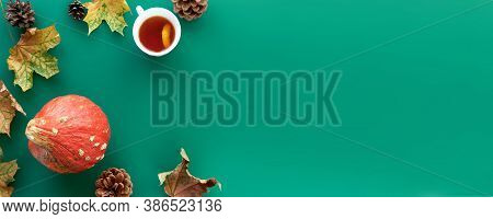 Autumn Composition. Frame Made Of Pumpkins, Dried Leaves, Pine Cones And Tes Cup Background. Templat
