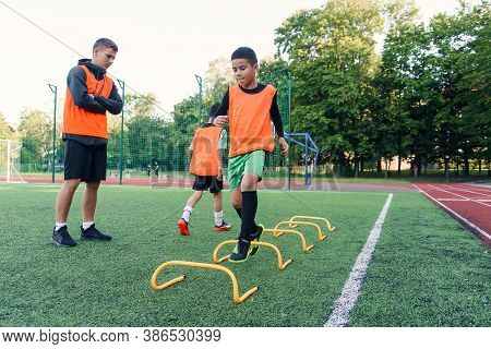 Childrens Football Players During Team Training Before An Important Match. Exercises For The Youth F