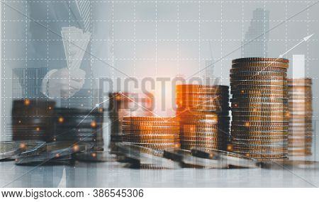 Double Exposure Of Graph And Rows Of Coins On City Night Background.finance And Business Concept.