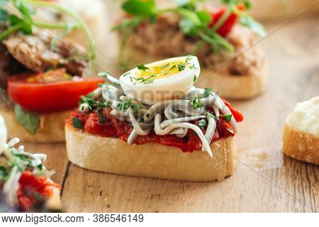 Closeup On Assorted Tappas With Different Toppings On The Wooden Board