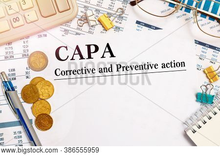 Paper With Corrective And Preventive Action Capa On The Table, Financial Documents, Calculator And C