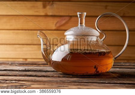 Teapot With Brewed Hot Tea On A Wooden, Cozy Background