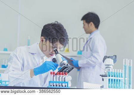 Two Asian Scientist Team Reserch Chemistry Science Tube Experiment Biotech Antibody Sample In Labora