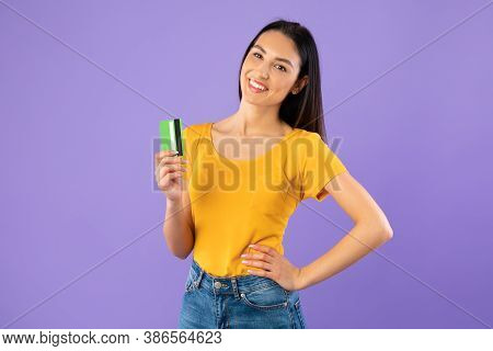 Easy Payment, Banking Concept. Portrait Of Smiling Young Female Model Holding And Showing Plastic Cr
