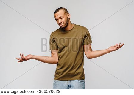 I Dont Know Gesture - Young Afrcian American Man Over Grey Background Being At A Loss, Showing Helpl