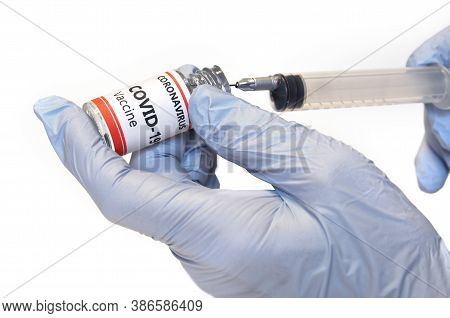 Doctor Holding A Syringe With Vaccine Against Covid-19 Isolated On White Background. Pharmaceutical 