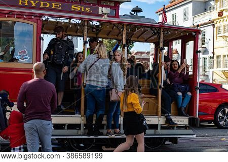 Powell And Hyde Cable Car Train With Some Tourists Near Beach Street, San Francisco, California, Usa