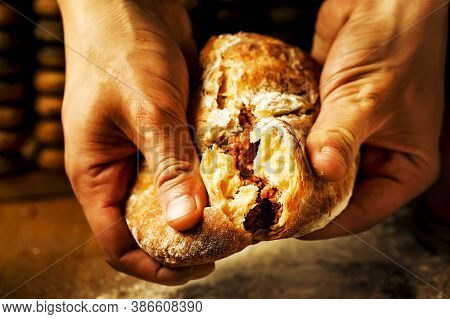 The Hands Of The Cook Break The Indian Naan. An Oriental Flatbread Stuffed With Meat In The Hands Of