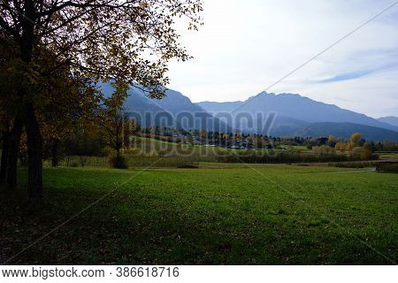 Countryside View In Levico, Trentino, Italy During Autumn. Fall Season Scenary With Mountains And Fi