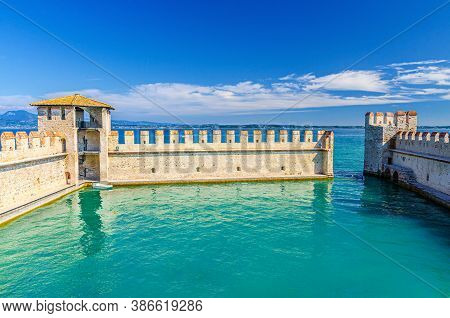 Sirmione, Italy, September 11, 2019: Small Fortified Harbor With Turquoise Water, Scaligero Castle C