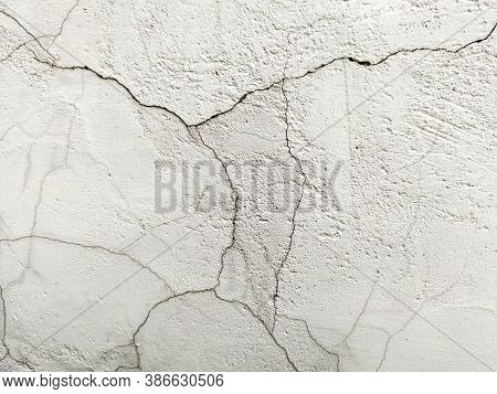 Grunge Background With A Cracked White Stone Wall. The Texture Of The Stone