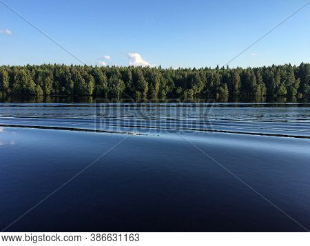 Summer Landscape With The Blue Surface Of The Lake And The Forest