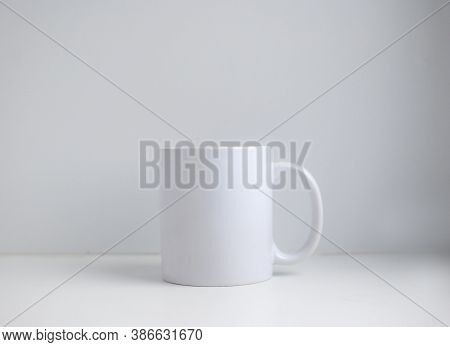 Simple White Mug Close Up On A Gray Background With Copy Space