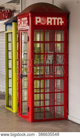 Manta, Ecuador - December 2, 2008: Closeup Of Red Public Porta Telephone Booth With A Yellow Telefon