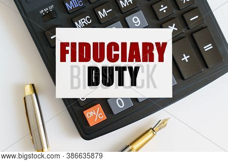 Business And Finance Concept. On The Table There Is A Pen, A Calculator And A Business Card On Which