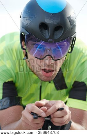 closeu of triathlon athlete riding professional racing bike at workout