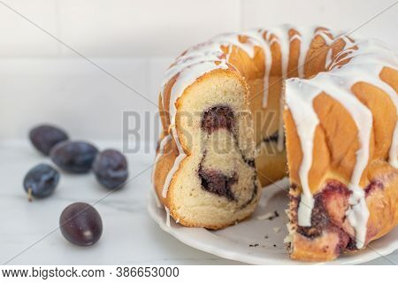 Typical German Poppy Seed Plum Gugelhupf Cake On A Table