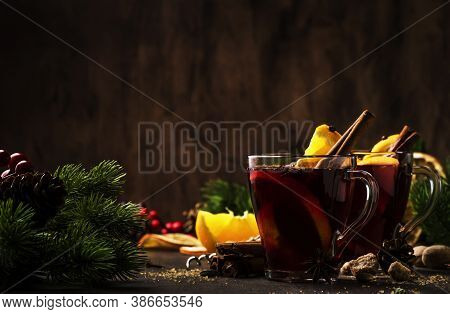 Xmas Hot Mulled Red Wine With Spices And Fruits On Wooden Rustic Table. Traditional Christmas Hot Dr
