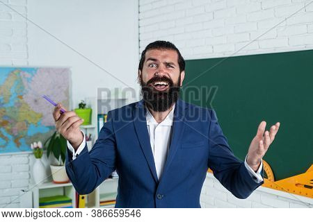 Speaker. Happy Mature Teacher Smiling. Cheerful Brutal Bearded Man Work In Classroom With Blackboard