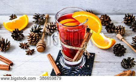 Christmas Mulled Wine With And Orange On Wooden Rustic Background. Selective Focus. Anise Stars And 