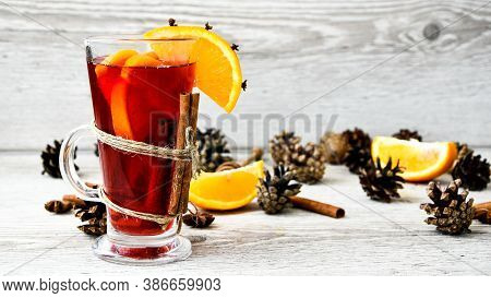 Christmas Mulled Wine With And Orange On Wooden Rustic Background. Selective Focus. Anise Stars And 