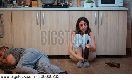 Wife Drinking Alcohol Near Drunk Husband Looking Desolated At Him. Traumatised Abused Terrified Beat