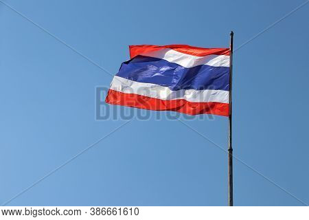 National Flag Of Thailand On Bright Blue Sky Background. Blown Away By Wind. Thailand Is One Of The 