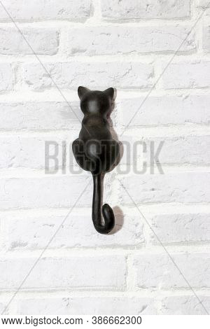Hanging Hook Shape Of Cat Install On The Wall. It Is A Piece Of Metal Or Other Material, Curved Or B