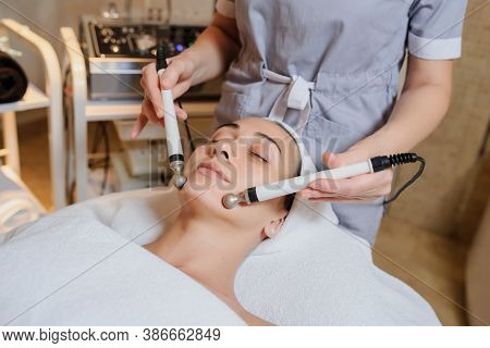 Lateral View Of Woman Facial Massage Spa Procedure. Electric Stimulation Facial Skin Care. Microcurr