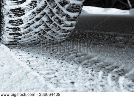 Car Tire In Snow On Road In Winter