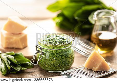 Wild Leek Pesto With Olive Oil And Parmesan Cheese In A Glass Jar On A Wooden Table. Useful Properti