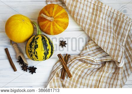 Small Pumpkins On White Wooden Background. Autmn Composition, Thanksgiving Day Concept. Halloween Fl