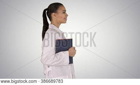 Happy Smiling Female Doctor Walking Holding Notebooks Or Documen
