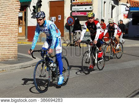 Orgiva, Spain - March 08, 2009 - Cyclists Travelling Through A Village Street, Orgiva, Spain - March