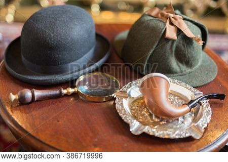 London, United Kingdom- June 2019: Sherlock Holmes Typical Objects On A Little Wooden Table: Deersta